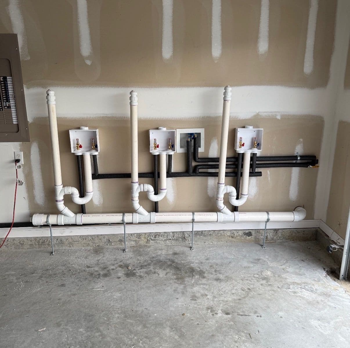 Triple Washer Drain Setup Installed in a Garage Conversion image