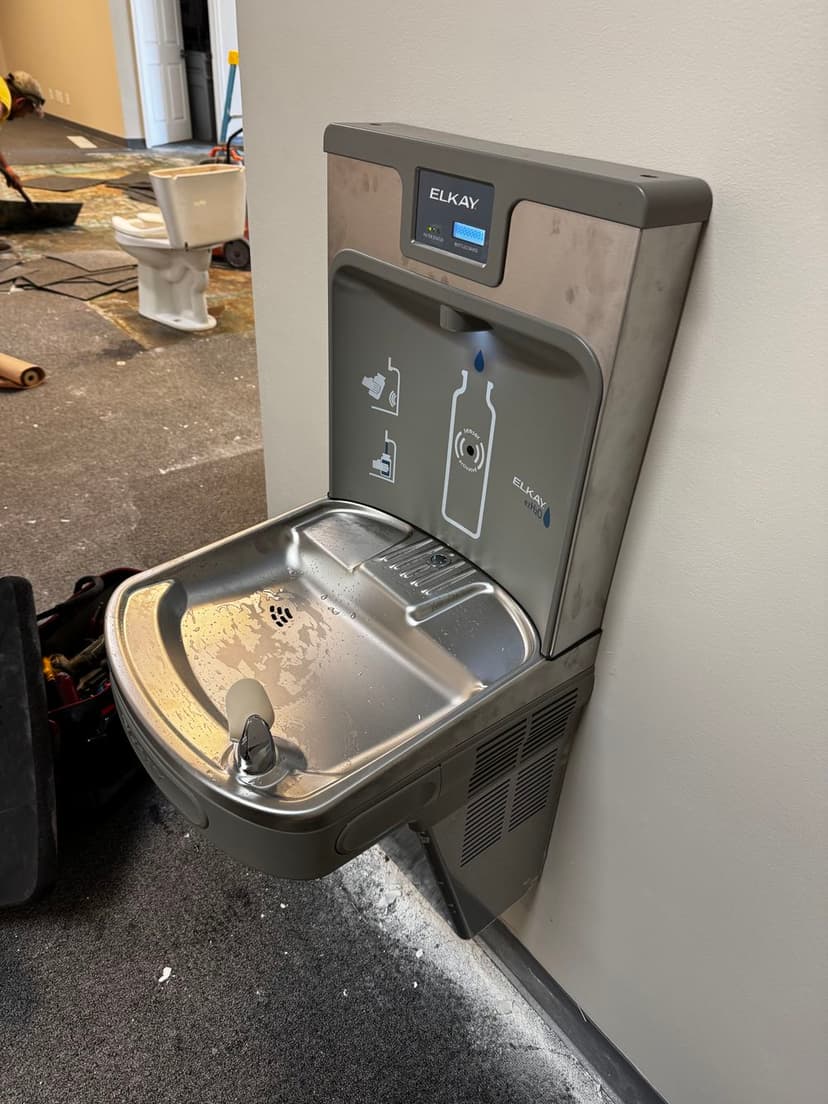 Elkay water fountain with bottle filler in an office renovation setting, showcasing modern design.